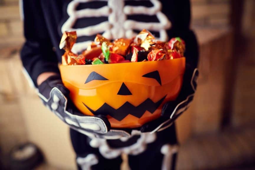 pumpkin face bowl holding candy