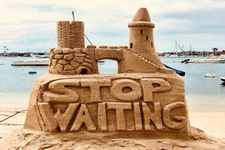Sandcastle saying stop waiting