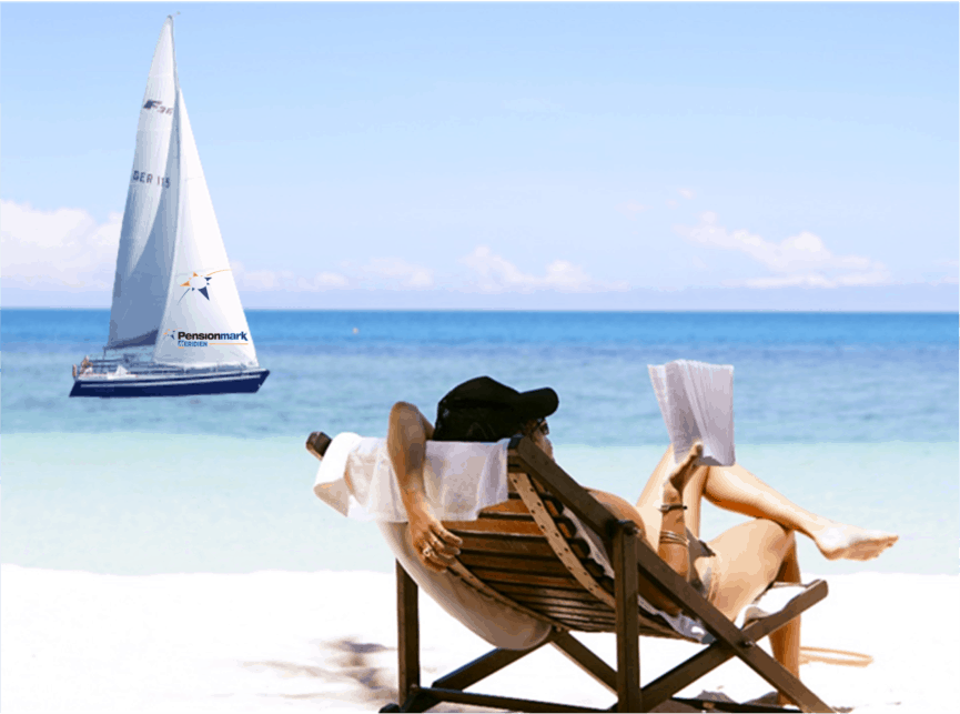 Person reading book on beach with a sail ship in background